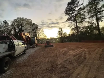 Excavator shaping soil during a basement excavation project